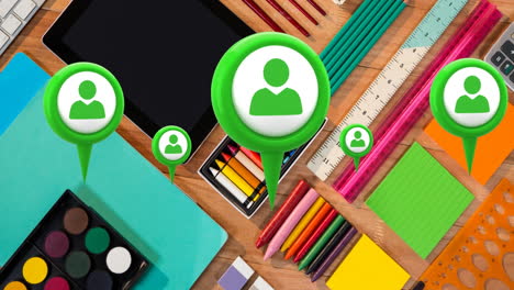 animation of multiple profile icons floating against close up of school equipment on wooden table