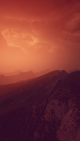 dramatic red sunset over misty mountains