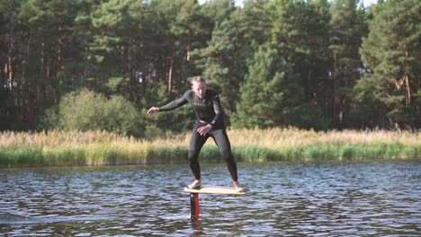 surfer on pump foil is foiling