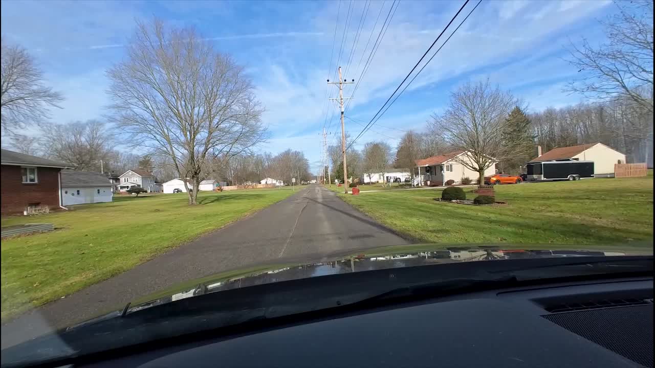 Driving through a quiet residential street on a sunny day