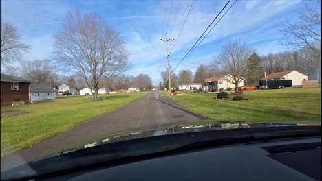 driving through a quiet residential street on a sunny day