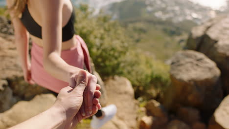 couple holding hands woman leading boyfriend climbing mountain hiking with girl friend enjoying outdoor travel adventure pov