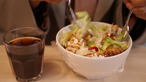 persona comiendo una ensalada de pollo
