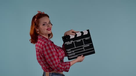 pin-up girl holding clapperboard