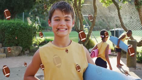 animation of american football balls over smiling caucasian boy