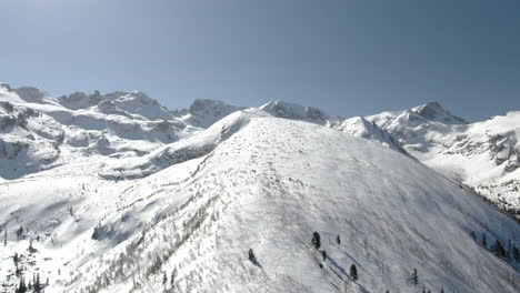 Drone-shot-of-snowy-peak-and-ski-slope-in-Malyovitsa-in-Bulgaria