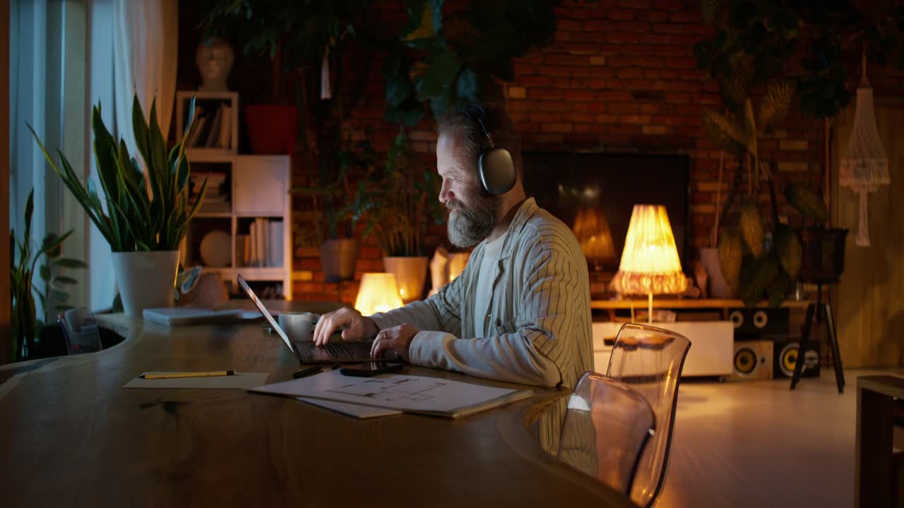 Man reviewing home design plans at night