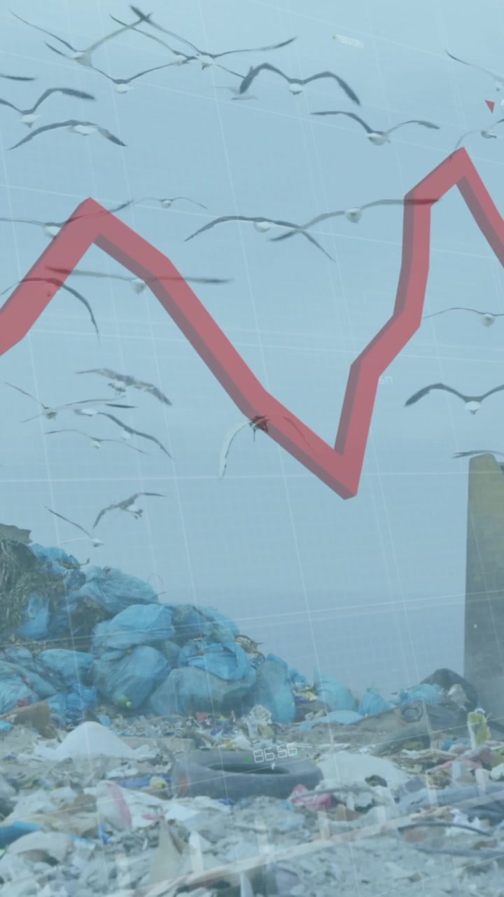 Red graph moving against bulldozer working on landfill with birds in the sky