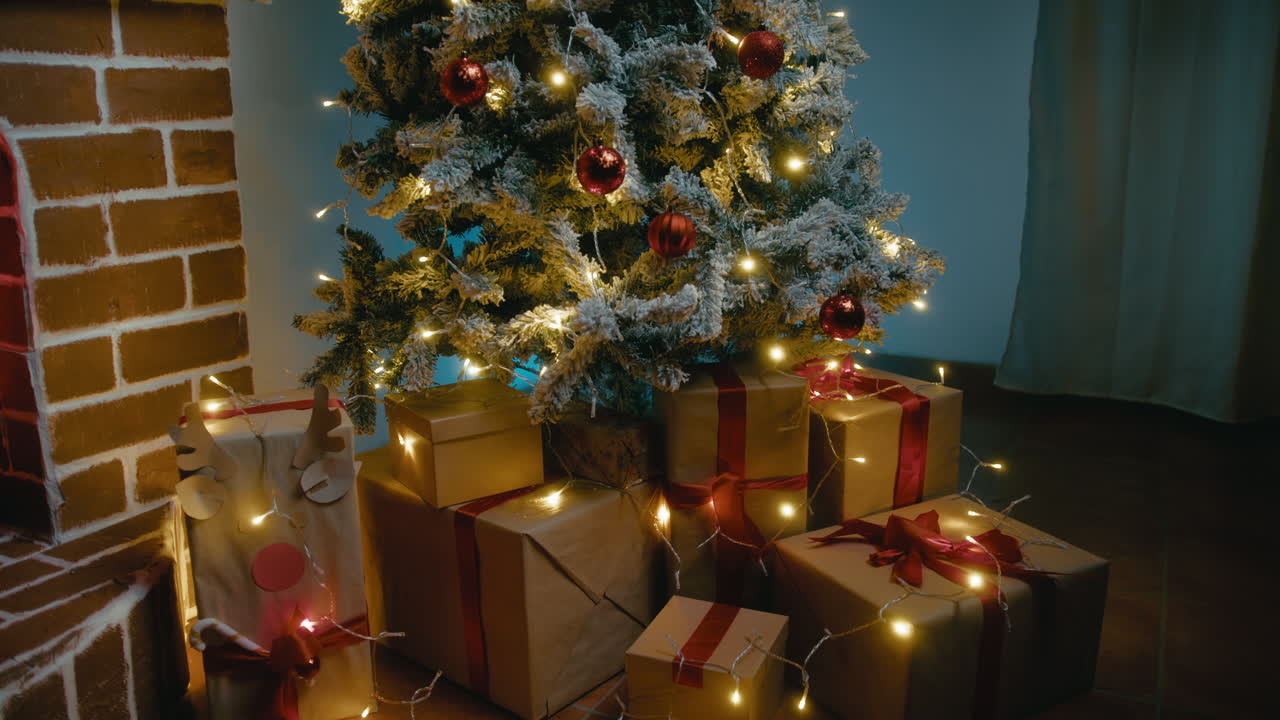 Snow-covered Christmas tree next to fireplace with ribboned presents