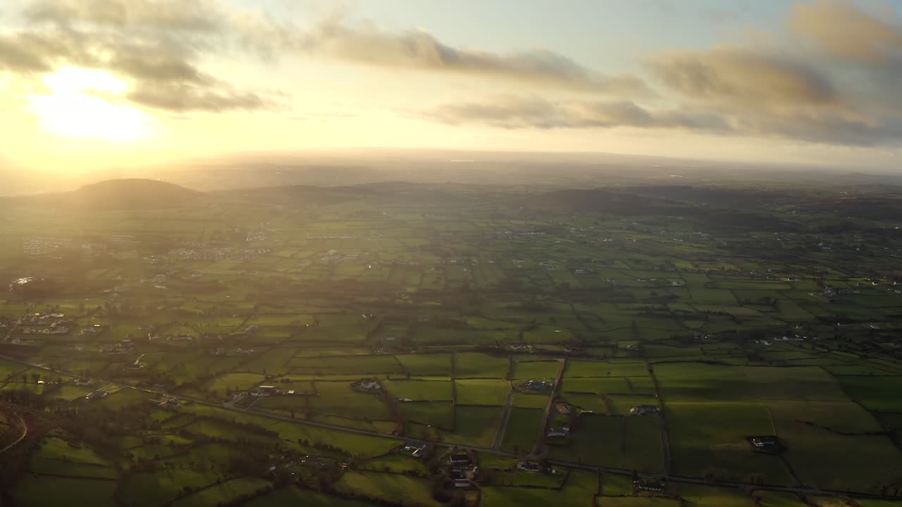 Wintery sunset at Ring of Gullion, Newry, Northern Ireland. December 2019. Drone slowly pushes forward from Slieve Gullion facing West towards Mullaghbane.