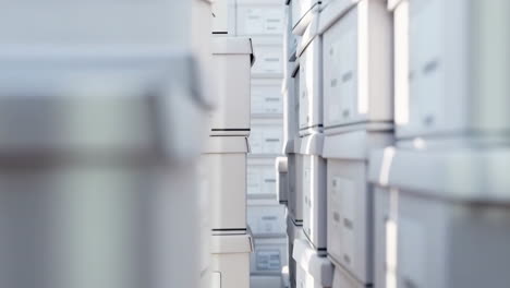 rows of stacked storage boxes in a warehouse
