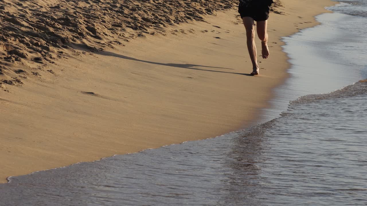 Man Running Barefoot on the Beach
