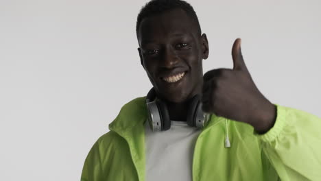 happy african american man on grey background.