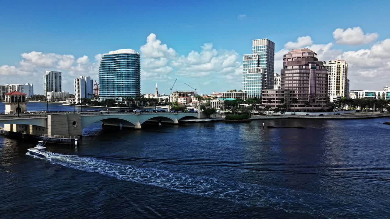 Aerial: cityscape with Royal Park Bridge, One Flagler and Phillips Point building in West Palm Beach, Florida, USA, establishing drone shot