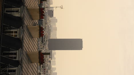 Vertical-video,-cityscape-view-from-above-of-the-Montparnasse-skyline,-at-dusk,-in-Paris,-France