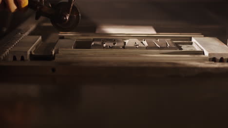 hand-setting type on a vintage letterpress