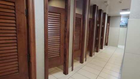 luxury tile hotel public bathroom stall doors with mirror sink and hand dryer