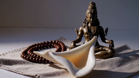 hindu deity statue and conch shell