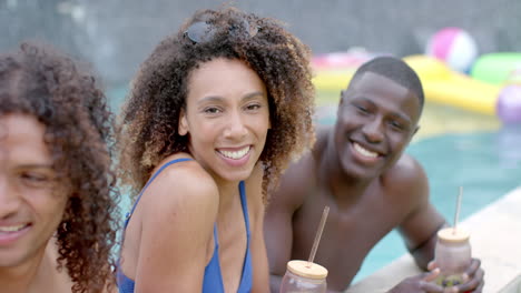 biracial woman and african american man enjoy a pool party