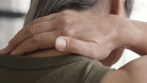 back view of a middle aged woman having neck pain 1