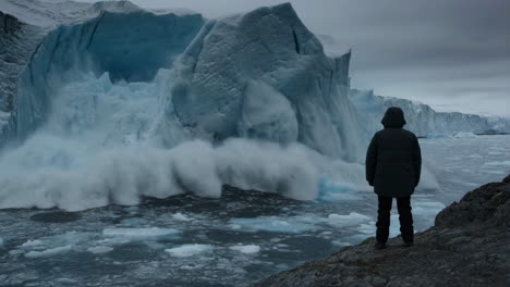person admiring a massive glacier landscape