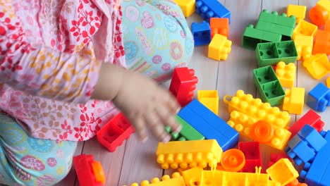 toddler playing with colorful building blocks