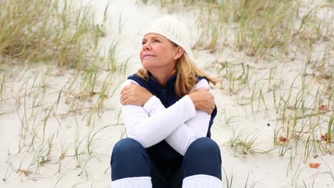 retired woman sitting on the beach