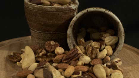 Light and shadow move across pile of assorted nuts, close-up view