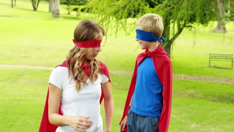 mother and son pretending to be superhero