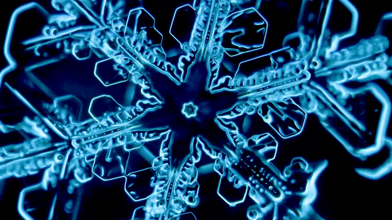 Blue snowflake ice crystal under microscope darkfield