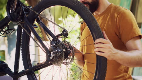 male cyclist repairing damaged bicycle