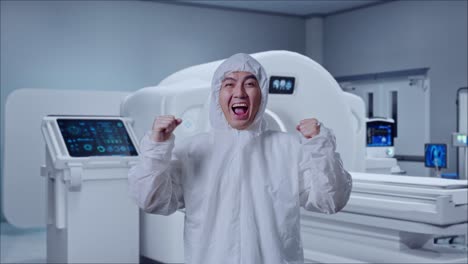 asian male scientist celebrating the succeed while standing with mri machine in the hospital