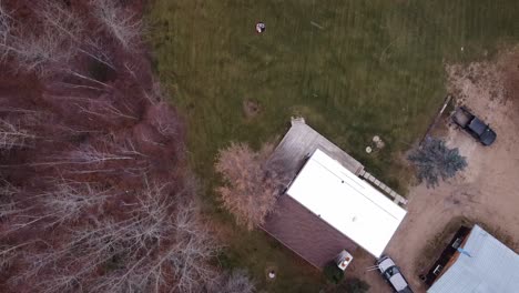 1-2 first day of snow birds eye view over rochester alberta fly over pine birch maple tree forests cottages and trailer rv homes and camp grounds at an altitudes of 100 feet on a cloudy day in canada