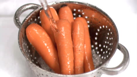 carrots being washed in super slow motion