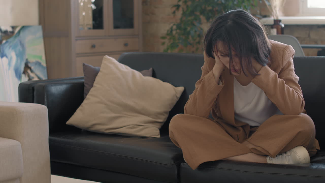 Slowmo of Devastated Young Woman on Couch
