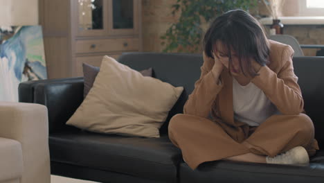 slowmo of devastated young woman on couch