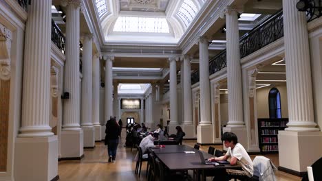 people studying in a grand library hall