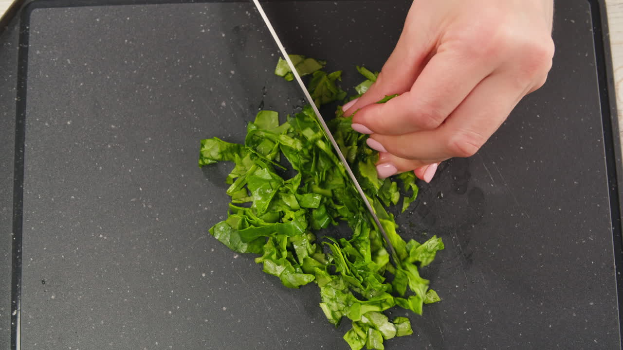 Chopping spinach with a knife