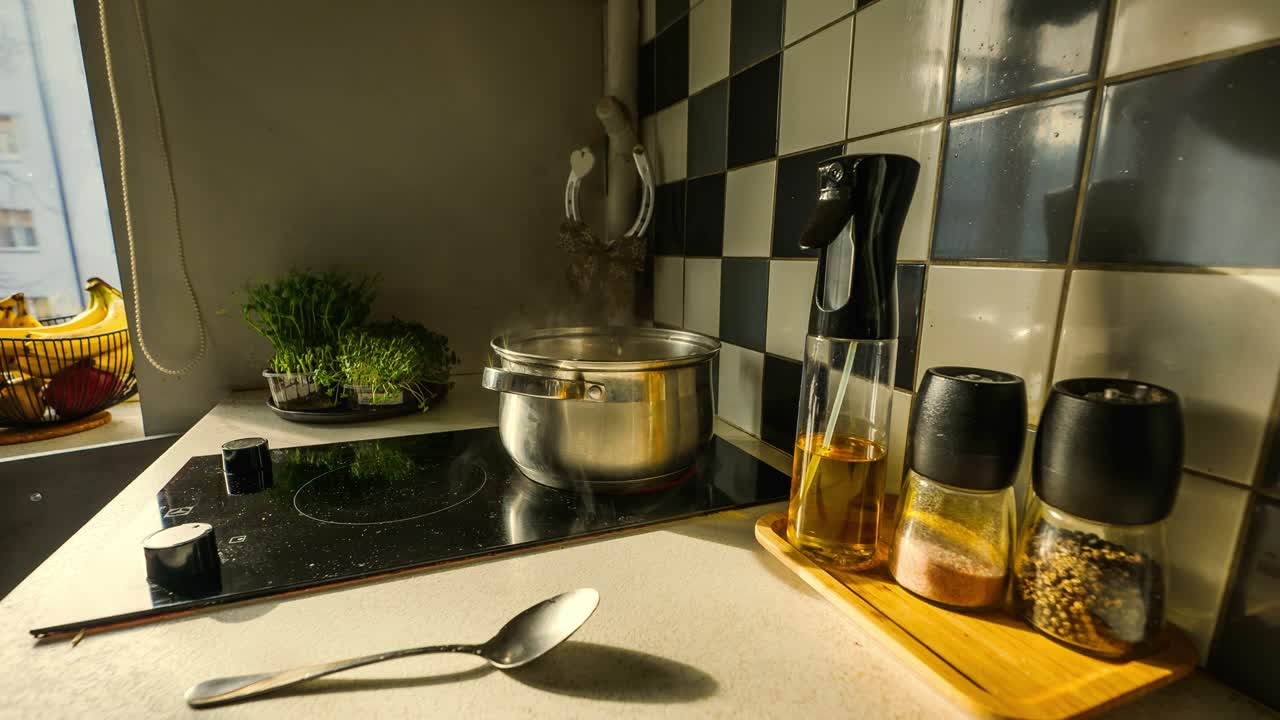 Golden sunset light fill Khrushchyovka kitchen as dumplings boil in bubbling pot