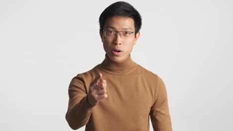 Serious-Asian-man-showing-no-gesture.