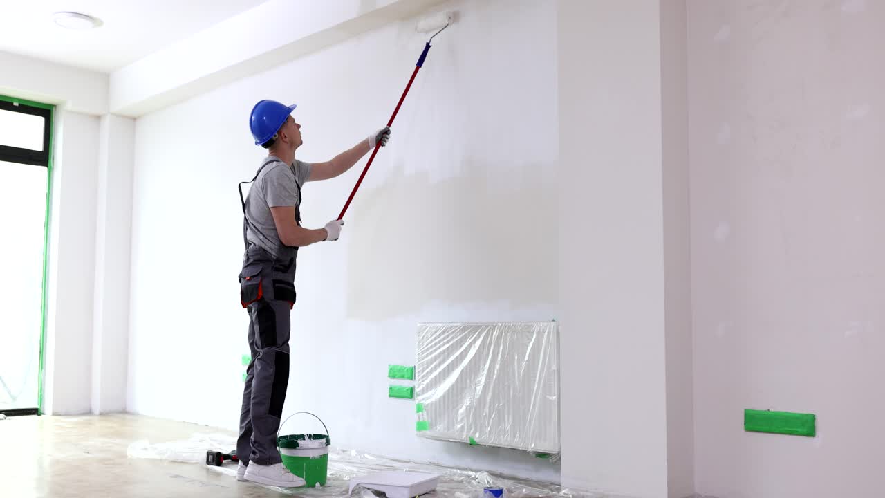 Painter renovating a room