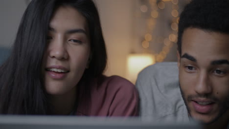 couple watching laptop at night