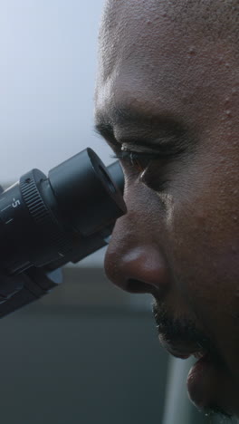 scientist using microscope