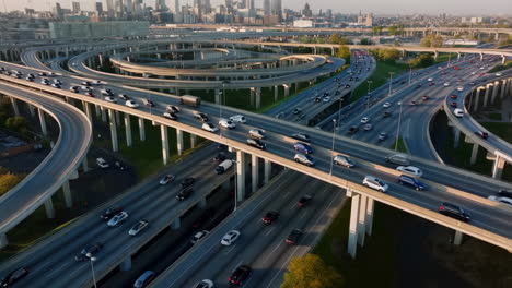 aerial view of a bustling highway interchange with city skyline