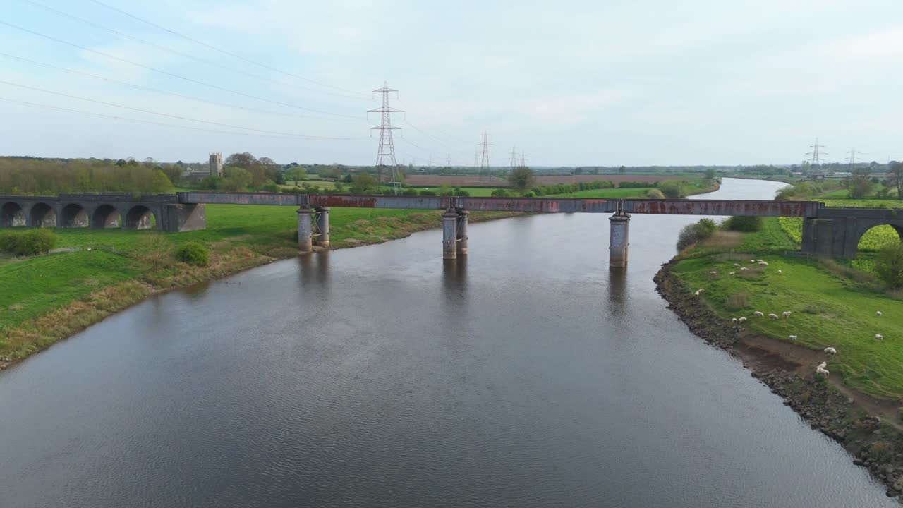 UK Infrastructure Scenic Aerial View of River Bridge, Green Agricultural Fields and Clear Skies on a Sunny English Day