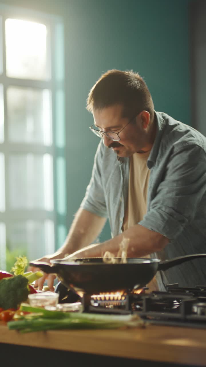 A man cooking vegetables in a kitchen