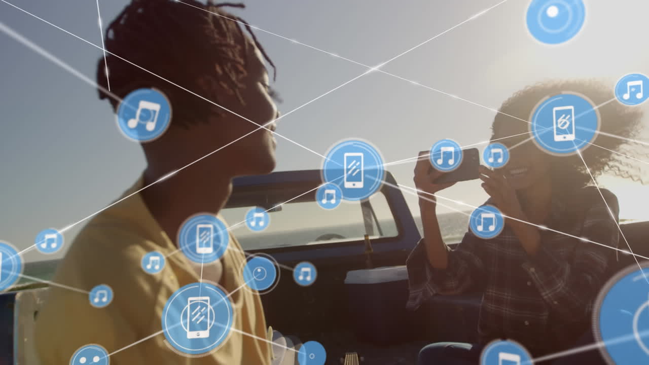 red de iconos digitales contra mujer afroamericana tomando fotos de su marido en el coche