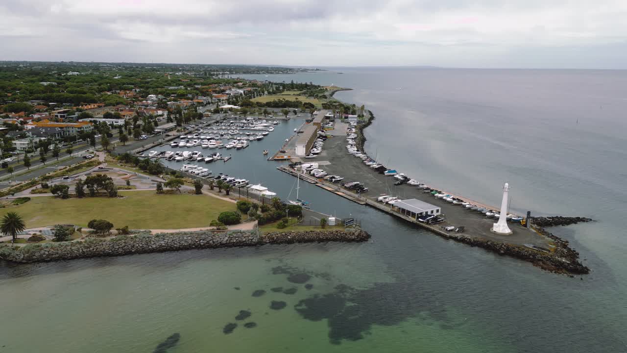 Aerial footage of St Kilda Lighthouse and the mini harbour of private yachts in Melbourne, Australia.
