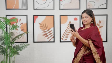 Happy-Indian-woman-using-phone-with-copy-space