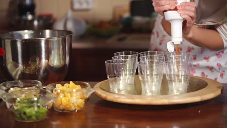 preparing a fruit dessert with topping